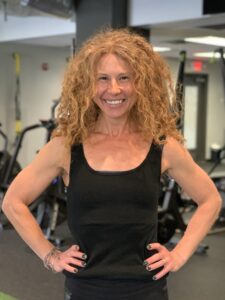 Jackie in a Black Tank Top With Curly Blond Hair